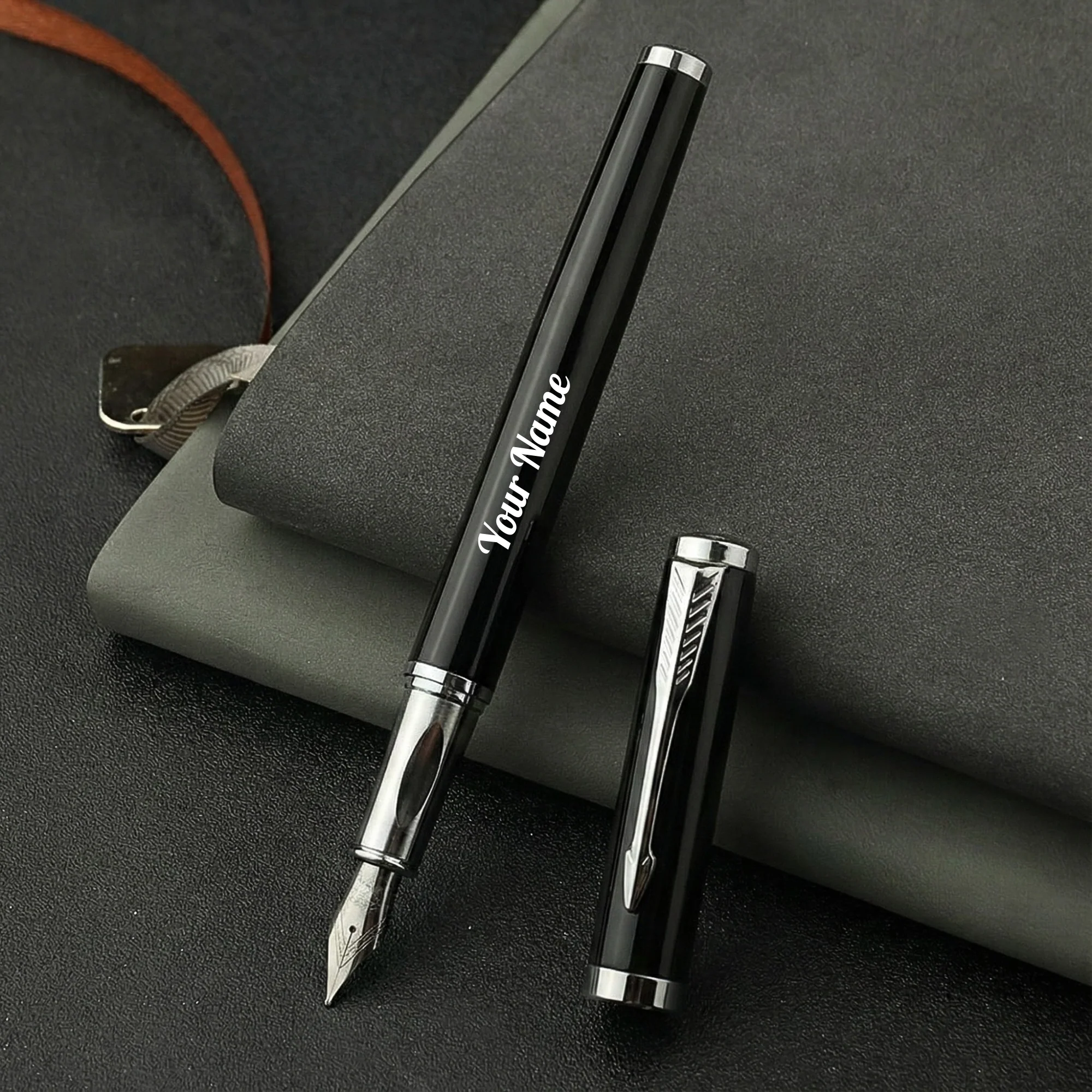 Set of five black and chrome fountain pens with custom laser-engraved names